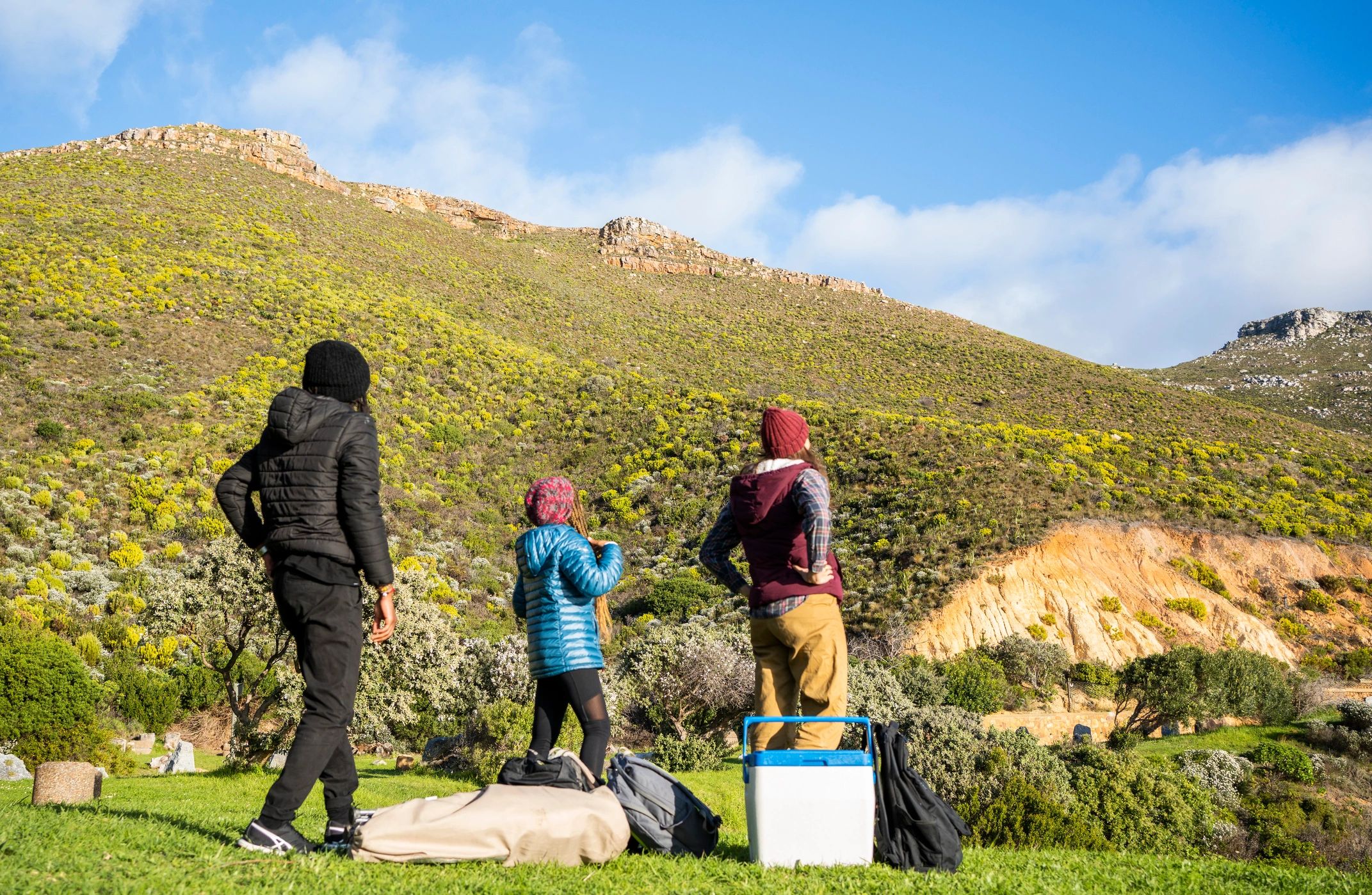 Friends looking at a mountain view before setting up camp