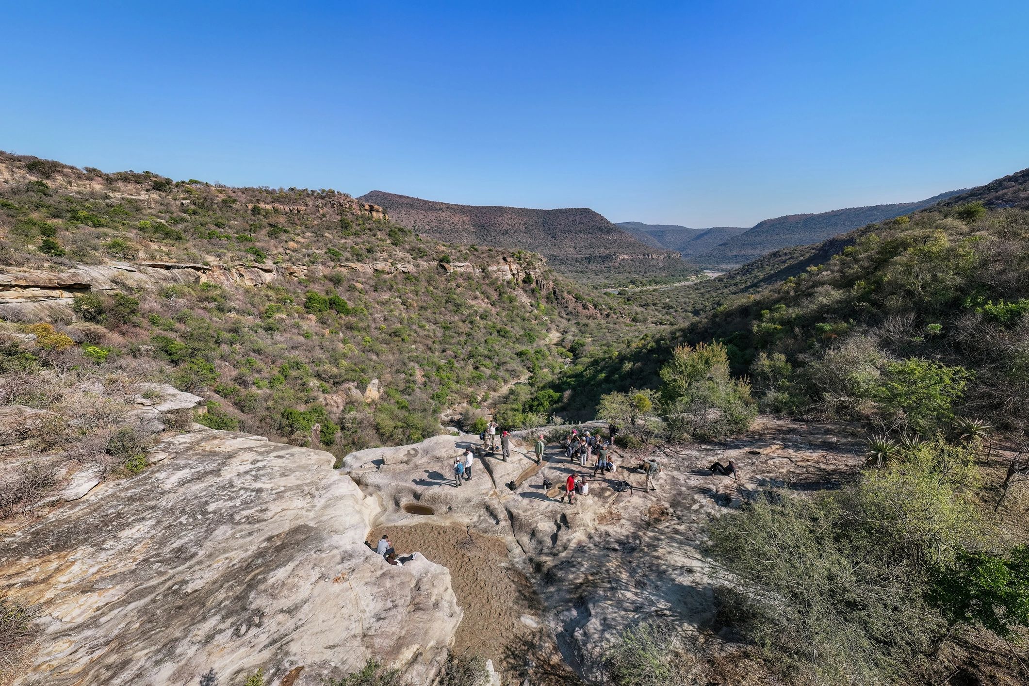 Group on a rocky outcrop overlooking a valley